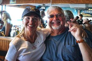 Happy couple smiling at the waterfront bar
