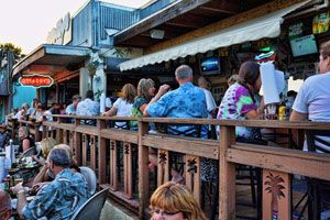 View from the deck railing showing outdoor diners and O'Maddy's signage