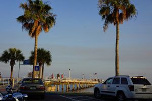 Gulfport waterfront pier at dusk with palm tree silhouettes